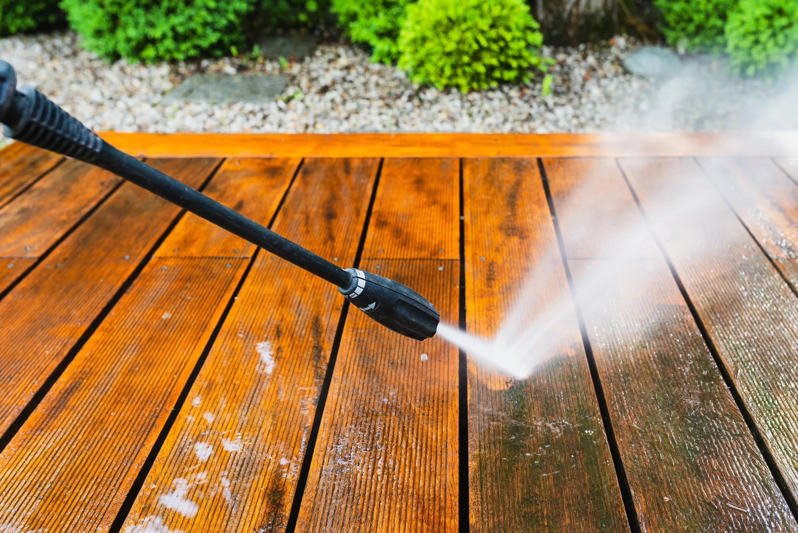 Pressure washer nozzle cleaning driveway